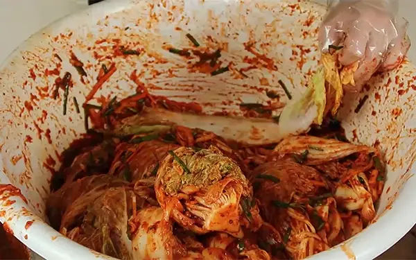 Making Red Cabbage Kimchi (배추김치) Step #4: Applying the paste, storing, and fermenting kimchi